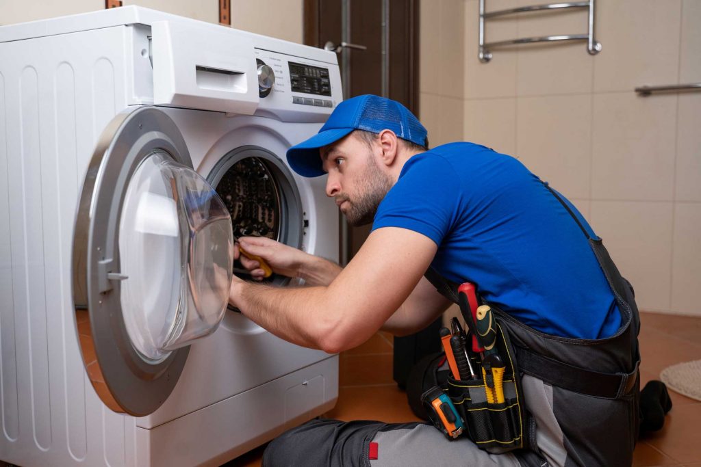 a technician repairing a washer and dryer repair atlanta